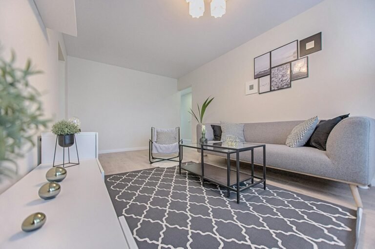 Three Gray Ornaments on White Wooden Desk Inside Living Room- Credit Vecislavas Popa